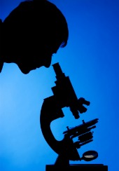 fibromyalgia cure, scientist looking through microscope for cure