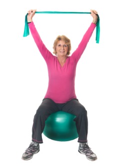 fibromyalgia physical therapy, woman using exercise ball and resistance bands