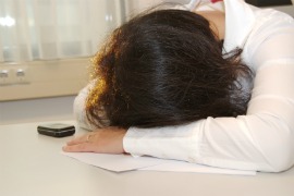 fibromyaliga fatigue, tired woman lying down at table